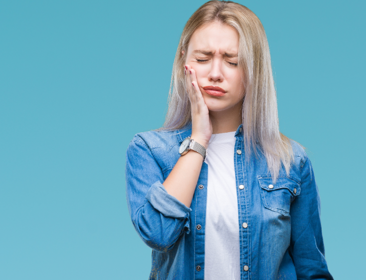 Woman holding jaw in pain